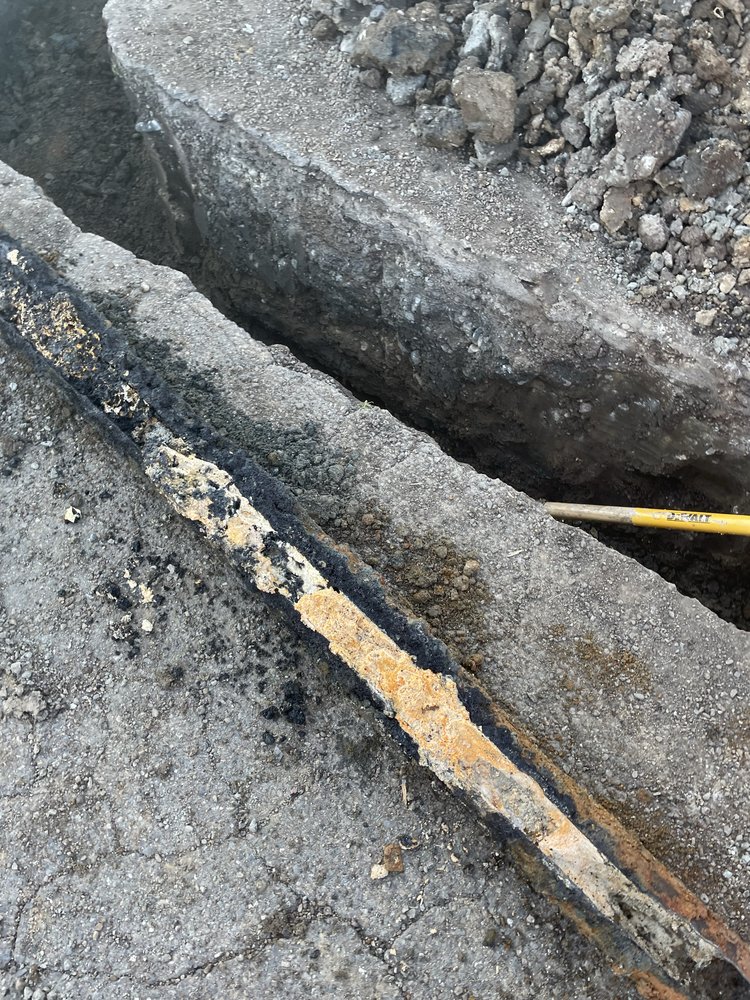 Corroded sewer pipe exposed in trench before trenchless repair